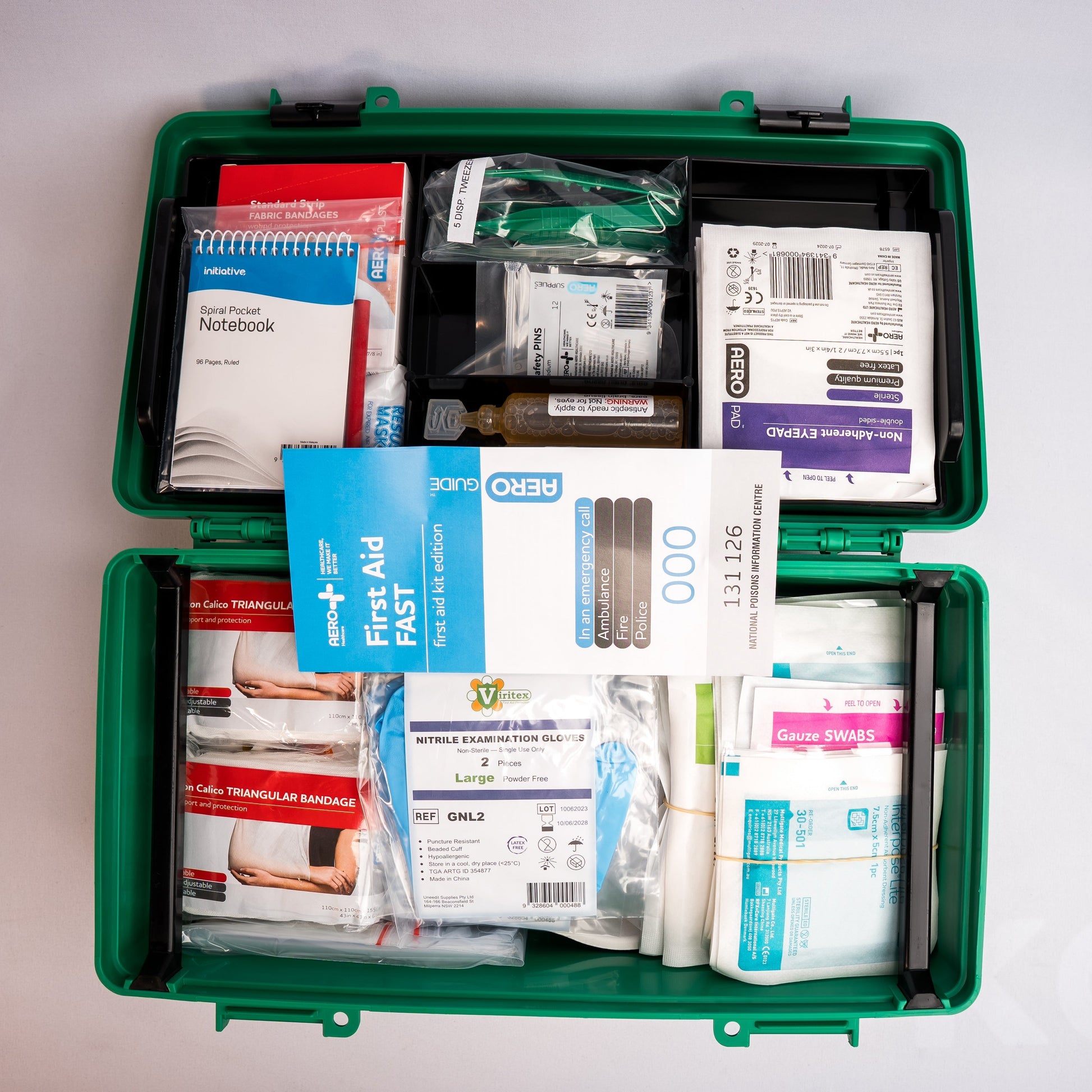 Open first aid kit with various supplies on a white background
